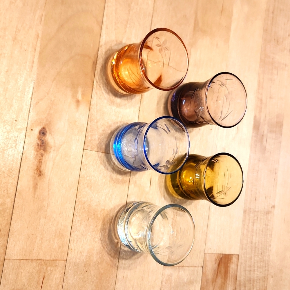 Set of 5 different colored glass salt dips with etched flower design.